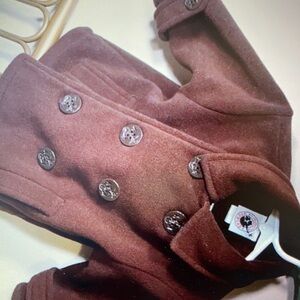 Features a classic double breasted collar jackets